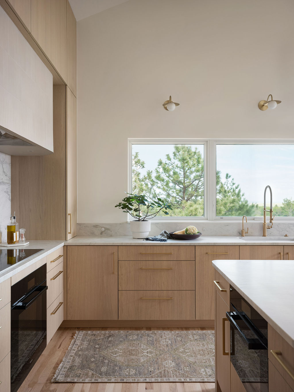 Milk oak kitchen with added windows above sink bringing natural light into Boulder home