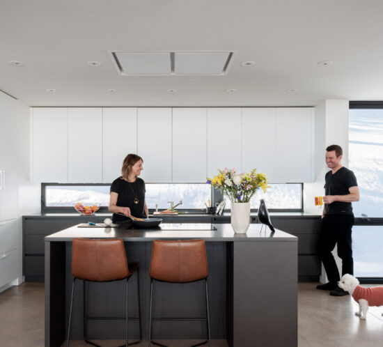 Flat panel kitchen cabinetry in ultramatte pure white with dark island storage in Golden home