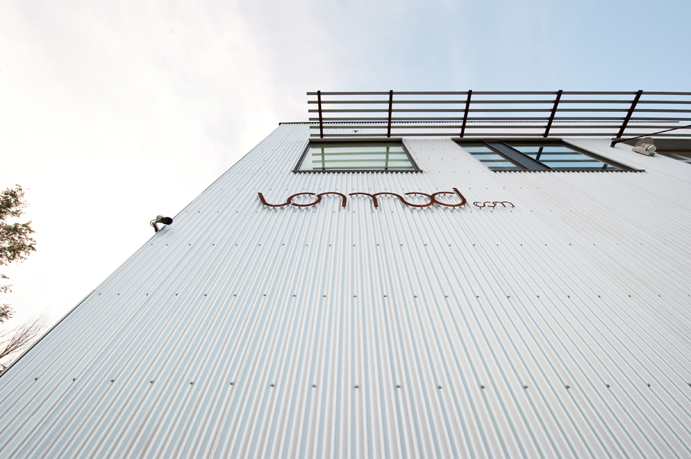 Exterior detail of the Vonmod building with corrugated metal facade and mounted signage in Denver