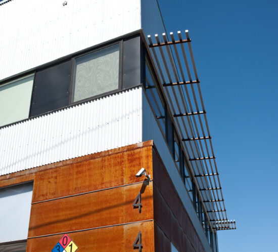 Corner detail of the Vonmod building showing corrugated metal and corten steel facade in Denver