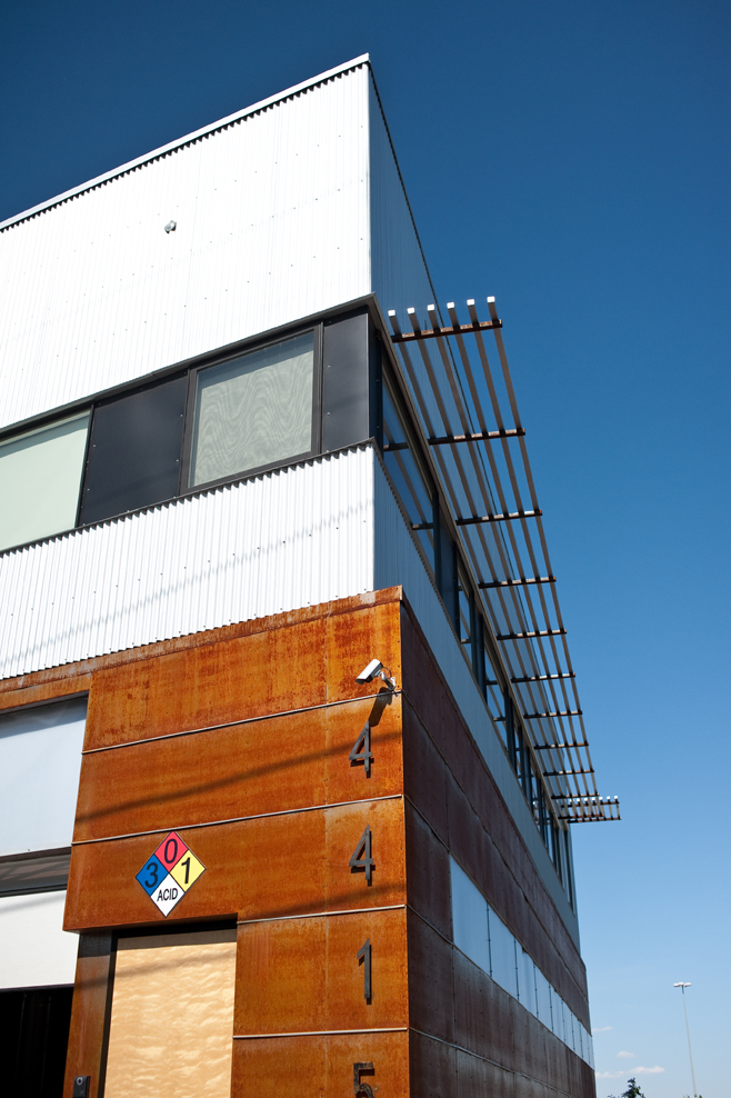 Corner detail of the Vonmod building showing corrugated metal and corten steel facade in Denver