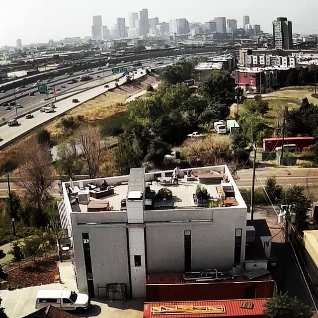 Aerial view of the Vonmod building with rooftop terrace and corrugated steel exterior in Denver