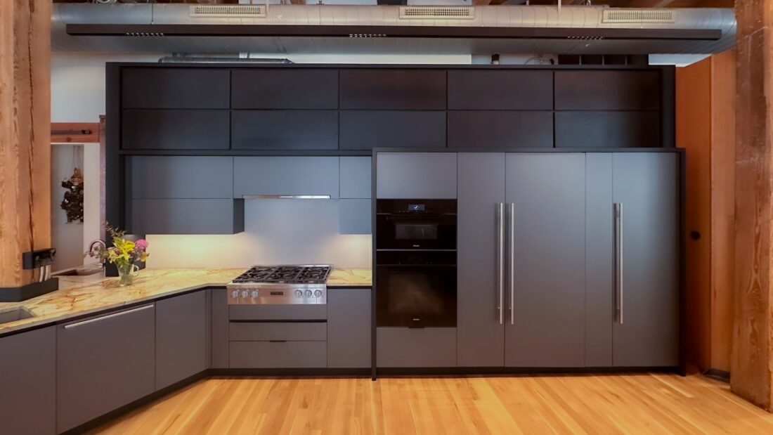Metallic grey kitchen cabinetry with integrated range, wall ovens, and full-height storage in Denver