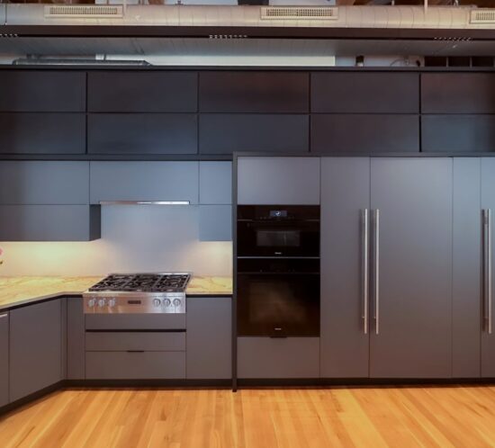 Metallic grey kitchen cabinetry with integrated range, wall ovens, and full-height storage in Denver