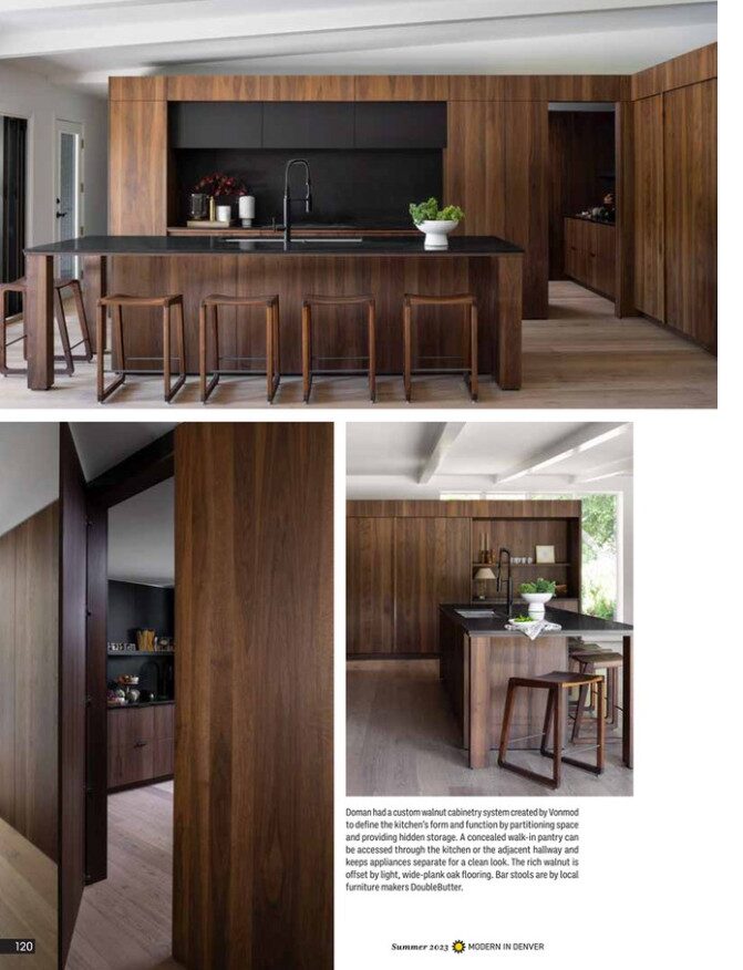 Walnut kitchen cabinetry with integrated island, concealed storage, and bar seating in open layout