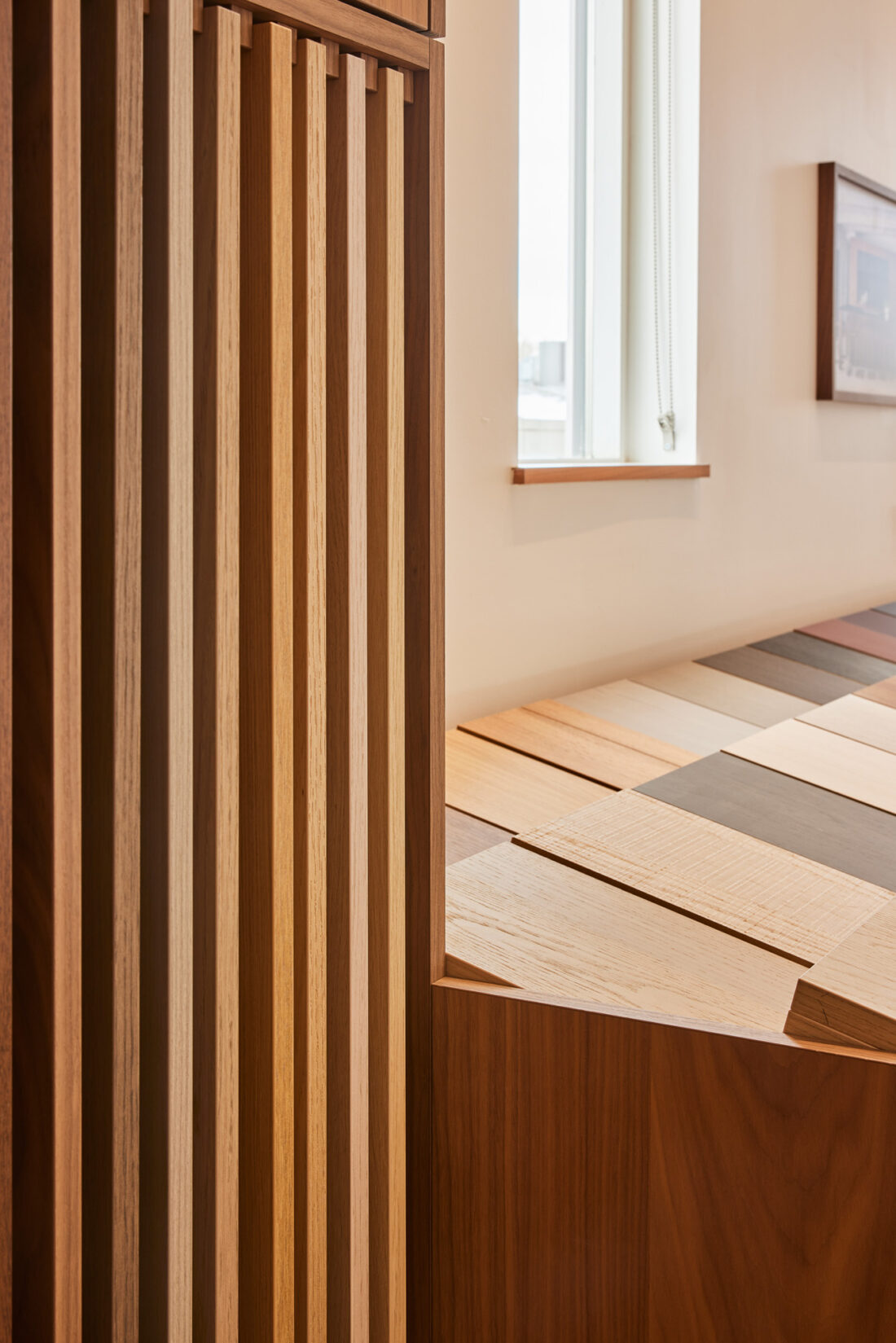Detail of full-size wood veneer samples creating a slatted panel construction in Denver showroom