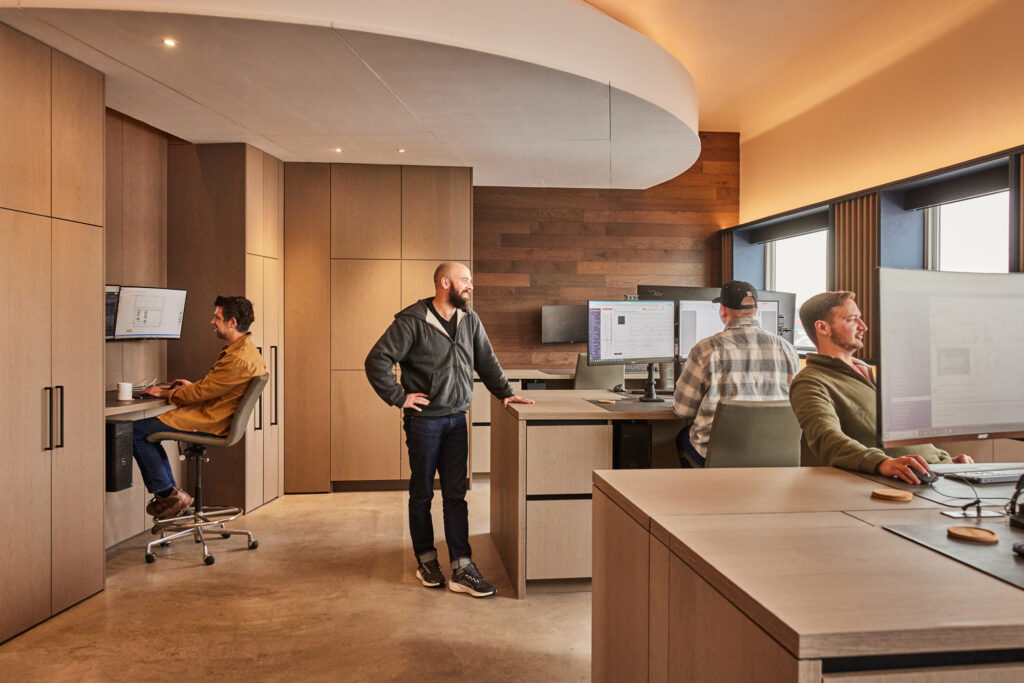 Studio workstations with built-in cabinetry in Manhattan oak at Vonmod showroom in Denver